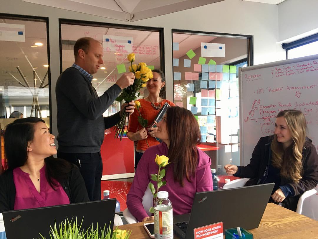 ADURO CEO Darren White handing out roses in celebration of International Women's Day